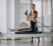 woman-with-pilates-trainer-practising-pilates
